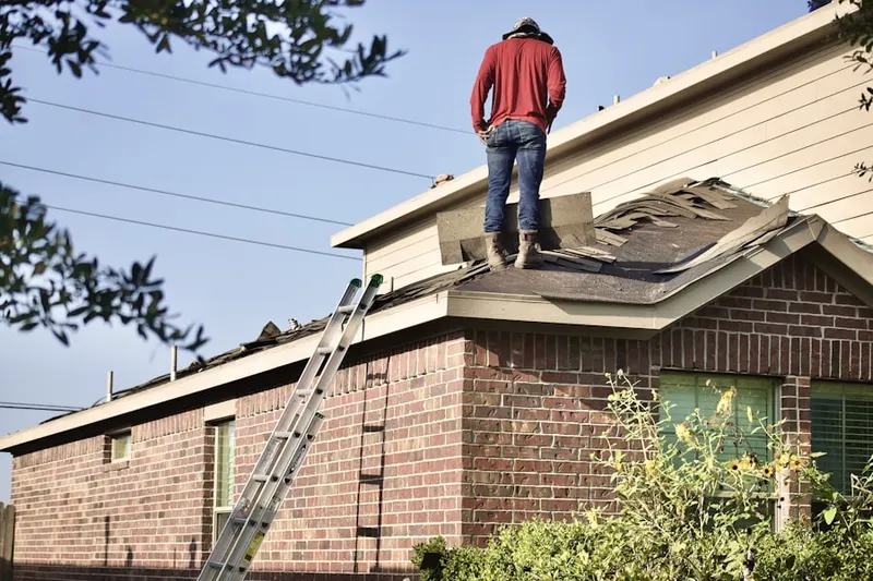 Professional roofer working on a residential roof in Crete
